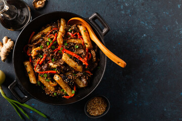 Traditional Korean Tteokbokki rice noodles with beef, vegetables and shitake mushrooms. Prepared in a wok.