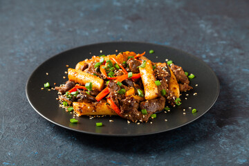 Traditional Korean Tteokbokki rice noodles with beef, vegetables and shitake mushrooms. Prepared in a wok.
