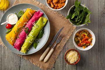 Colorful pancakes with chicken and lb vegan stuffing. Naturally colored with juice or seasoning. Served with sauce or yoghurt.