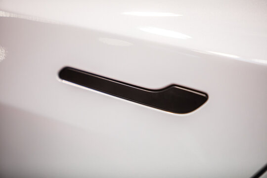 Modern door handle of a white car