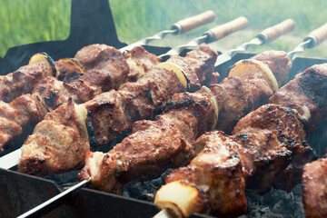 Marinated shashlik preparing on a barbecue grill over charcoal. Shashlik or Shish kebab popular in Eastern Europe. Shashlyk (skewered meat) was originally made of lamb. Roast Beef Kebabs On BBQ Grill.