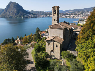 Fototapeta na wymiar Drone view at St. George church and the bay of Lugano on the italian part of Switzerland