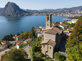 Fototapeta na wymiar Drone view at St. George church and the bay of Lugano on the italian part of Switzerland
