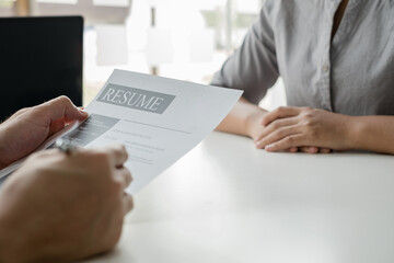 Business people hold a resume and talk to job applicants for job interviews about careers and Their personal history in the company. Recruitment concepts