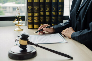 Professional woman lawyers work at a law office There are scales, Scales of justice, judges gavel, and litigation documents. Concepts of law and justice