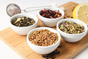 Concept of cooking tea with different types of tea on white background