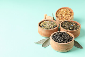 Concept of cooking tea with different types of tea on mint background