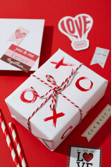 Valentine's Day accessories on red background, close up