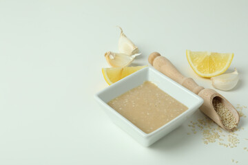 Concept of tasty food with tahini sauce on white background