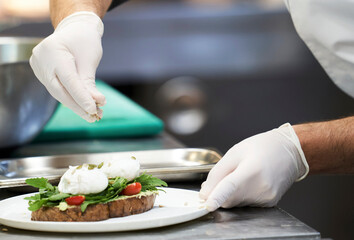 Chef cooking food in restaurant kitchen, close-up