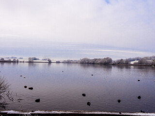 Fototapeta na wymiar First wonters snow at Pickmere Lake, Pickmere, Knutsford, Cheshire, UK