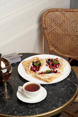 Crepes served with fresh berries and apples