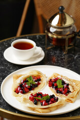 Crepes served with fresh berries and apples