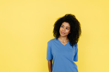 Afro woman contemplating against yellow background