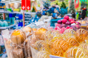Colorful Christmas balls are sold at the department store. New Year's Eve sale of tree decorations and Christmas toys.