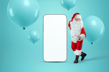 Smartphone mockup image, environment to showcase mobile app design, creative background. Smartphone for your advertising. Santa claus is standing next to a large smartphone. Christmas advertisement.