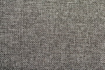 The texture of beige fabric matting as a background for the design.   Abstract pattern of natural fabric.