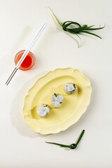 Chives Dumpling on Blue Plate and Bamboo Steamer, Copy Space for Text. Served with Red Sauce