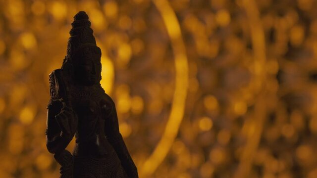 Statue of Parvati goddess, wife of Shiva, Hinduism religion. Turntable, light fading in, turning on beam.