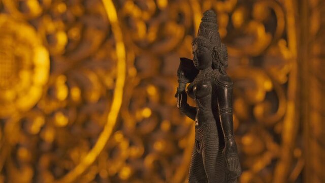 Statue of Parvati goddess, wife of Shiva, Hinduism religion. Turntable, light fading in, turning on beam.