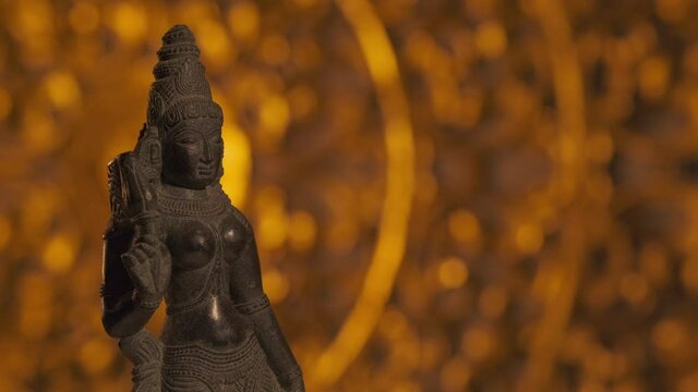 Statue of Parvati goddess, wife of Shiva, Hinduism religion. Turntable motion, light fading out.
