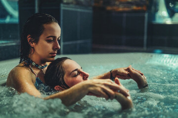 beauty relaxed woman is massaged in a whirlpool.