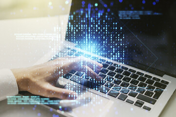 Creative code skull hologram and hands typing on computer keyboard on background, cybercrime and hacking concept. Multiexposure © Pixels Hunter