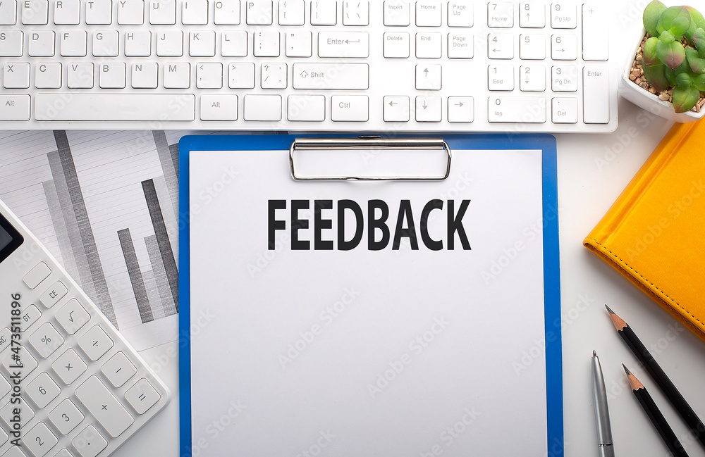 Poster feedback written on the paper with keyboard, chart, calculator and notebook