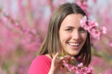 Woman smiling with perfect teeth in a field