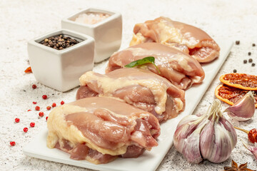 Raw chicken thigh without bones or skin. A useful ingredient for preparing healthy food, spices