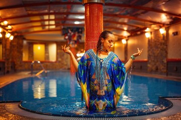 Pretty young woman relaxing in the pool.