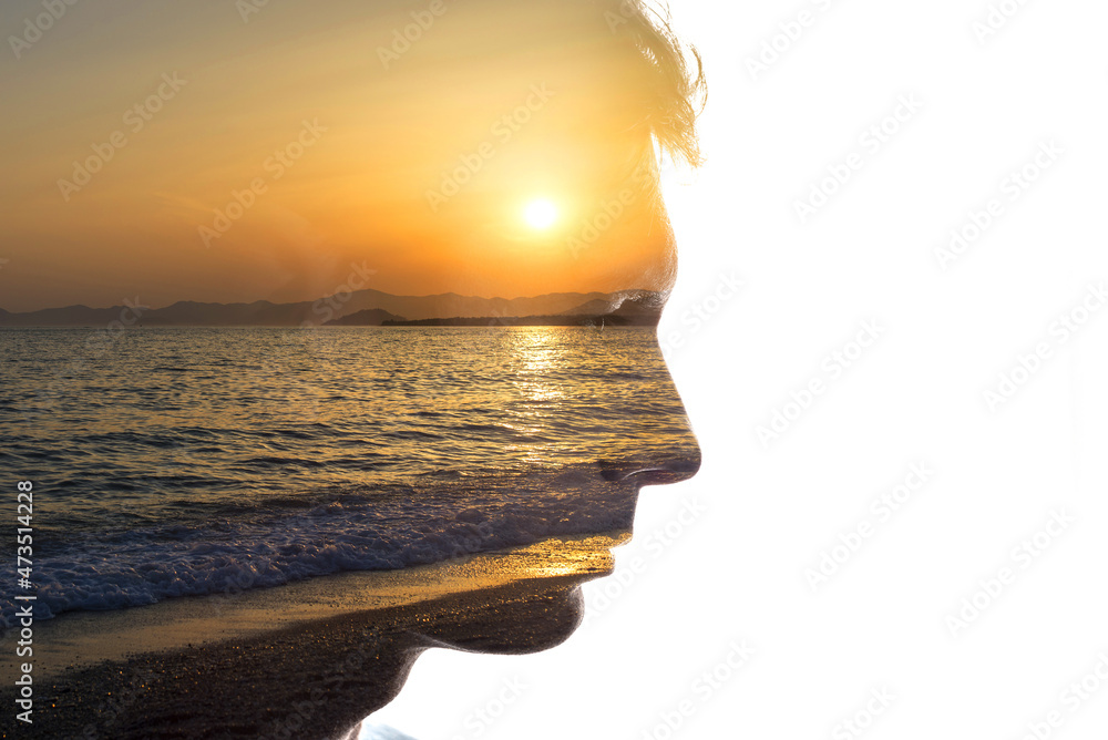Poster combination of the silhouette of a man face and a seascape with a sunset. concept of unity of nature