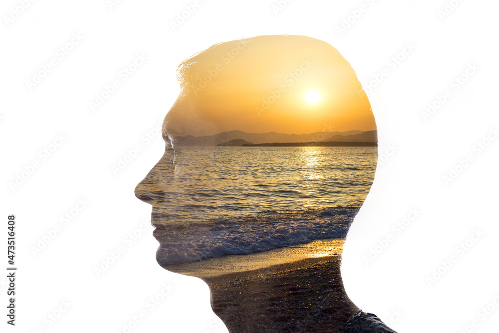 Poster combination of the silhouette of a man face and a seascape with a sunset. concept of unity of nature