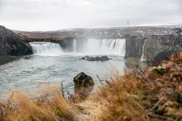 Fototapeta premium Goðafoss Waterfall Iceland in autum with yellow green orange grass