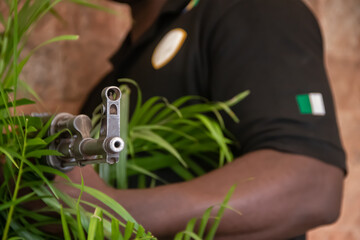 Member of Nigeria special forces holding Kalashnikov aka AK47, resting after military operation in Borno State, Nigeria