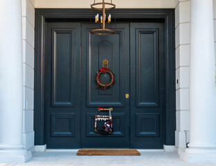 Christmas wreath decorated house entrance dark green door. Athens, Greece.