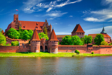Fototapeta na wymiar Malbork castle by the Nogat river at summer, Poland.