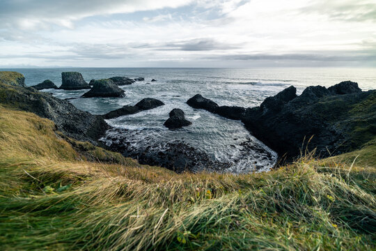 Arnastapi Iceland view to ocean with windy gras and sunlight