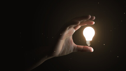 Hand holding creative idea electric light bulb or glowing inspiration lightbulb invention power and...