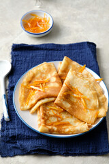 Crepes suzette with orange sauce and zest.