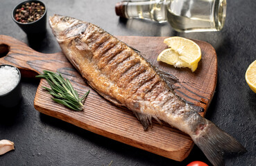 grilled sea bass fish on a stone background