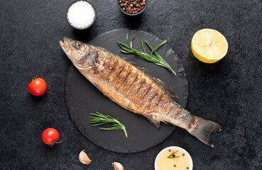 grilled sea bass fish on a stone background