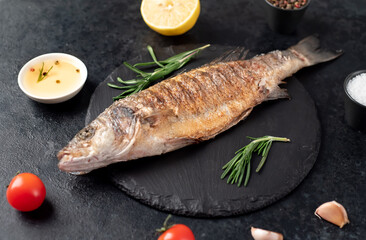 grilled sea bass fish on a stone background