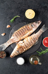 grilled sea bass fish on a stone background