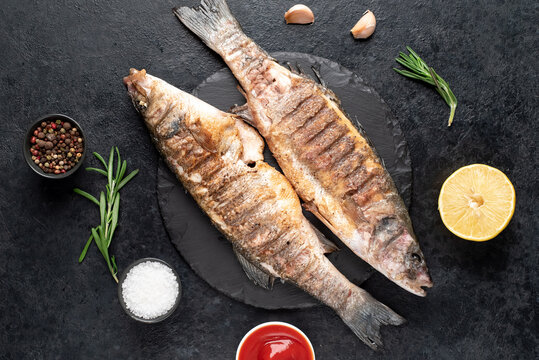 grilled sea bass fish on a stone background