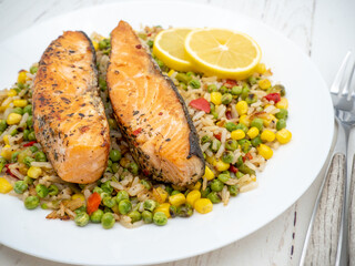 salmon steak on a bed of assorted vegetables