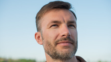 Fototapeta premium Portrait of a man with a beard looking aside.