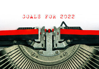 Vintage typewriter text GOALS FOR 2022 Red words paper background