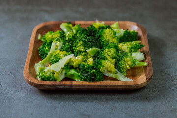 Vegetarian food. Broccoli on wooden plate