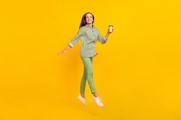 Fototapeta na wymiar Full body profile side photo of young pretty woman jump go drink latte americano travel isolated over yellow color background